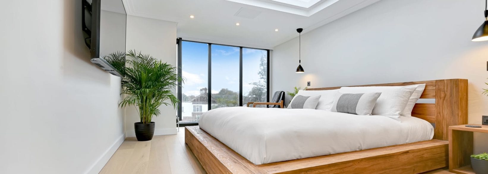 bedroom with large windows in Hip to Gable & Dormer loft conversion, at a house in Hither Green South East London SE12.