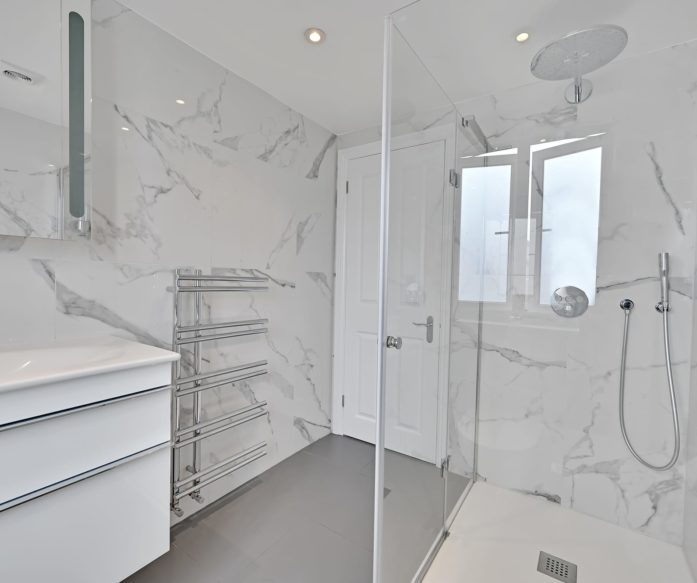 contemporary bathroom in a rear dormer loft conversion at a property in Norbury, South West London,