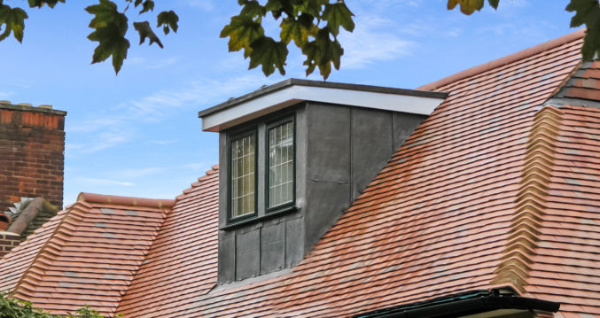 front of a dormer loft conversion clad in lead with leaded window in Southfields SW18