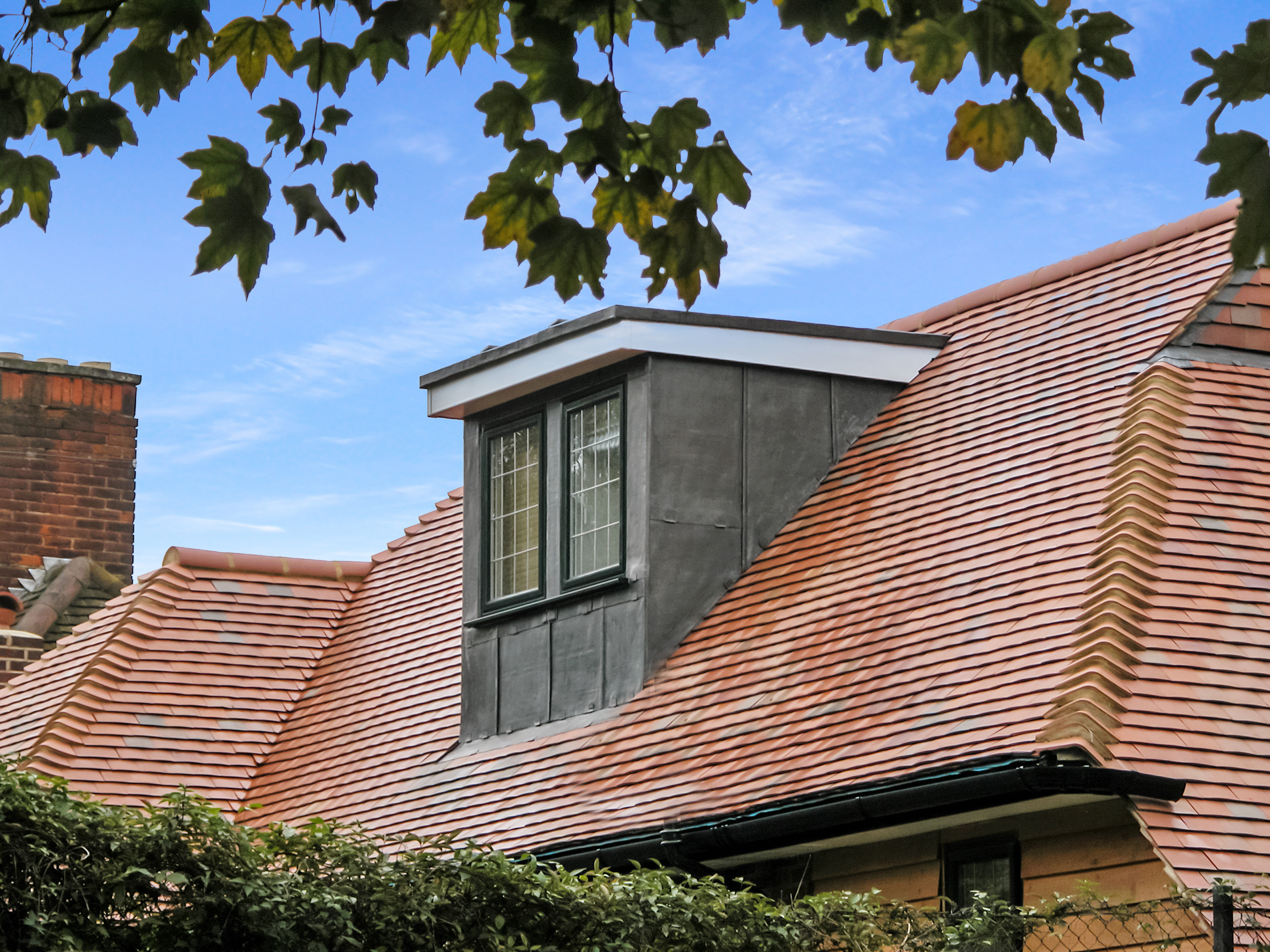 front of a dormer loft conversion clad in lead with leaded window in Southfields SW18