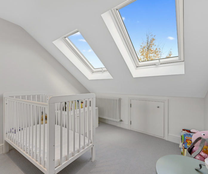 cot in nursey bedroom of an L-Shaped Dormer loft conversion, at a home in East London, E11
