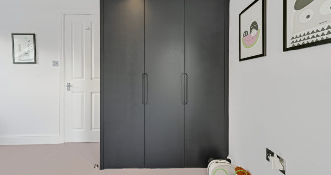 large grey wardrobe, part of an L-Shaped Dormer loft conversion, at a home in East London, E11