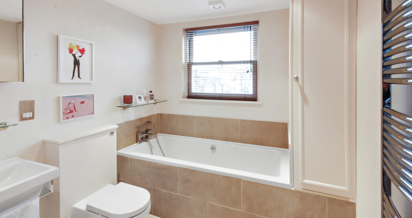 tiled bathroom in a L-Shaped Mansard loft conversion at a home in Sydenham South East London, SE26