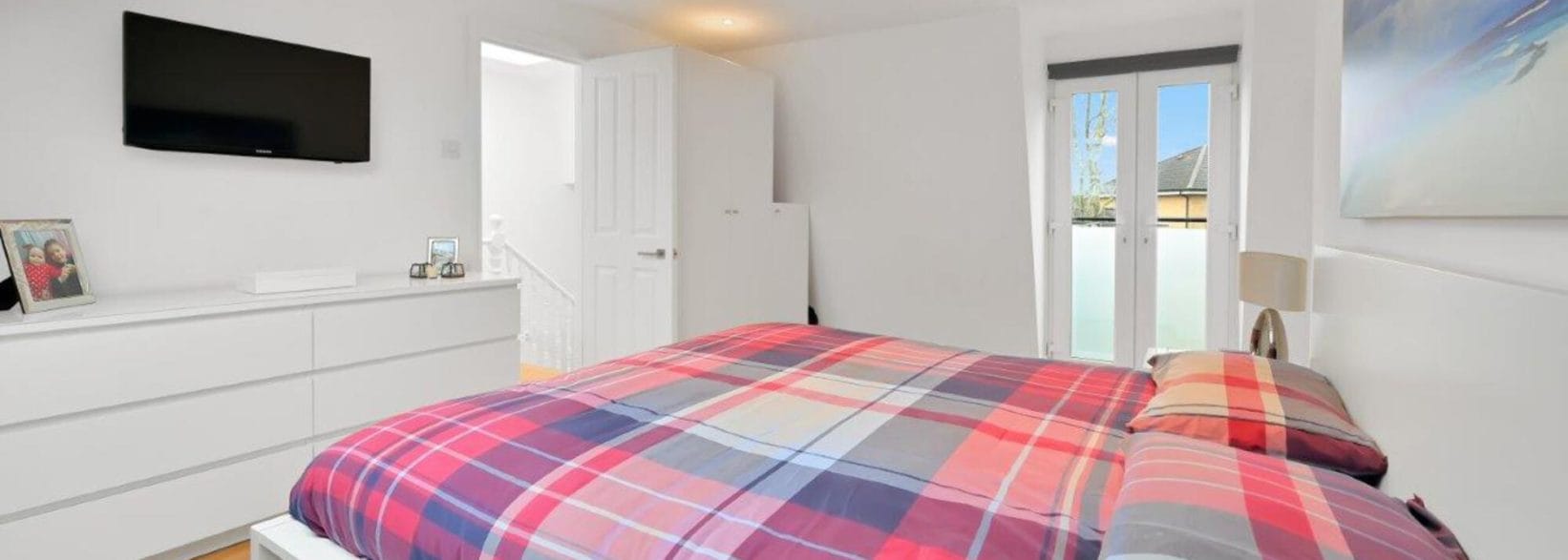 Bedroom with french doors in an L-shaped Mansard Loft Conversion in Tooting, South West London, SW17
