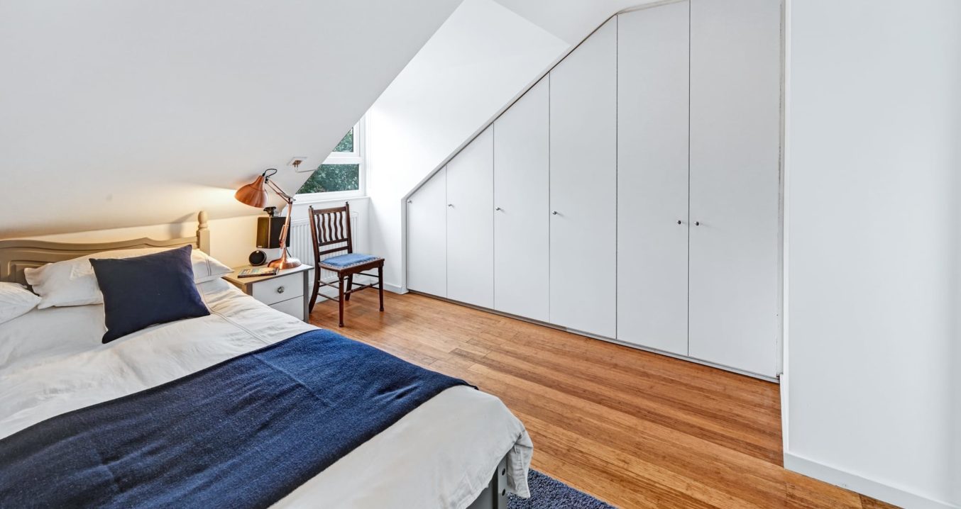 bedroom with white wardrobes in a Pitched Roof Dormer Front & Rear loft conversion at a property in Poplar, East London, E14.