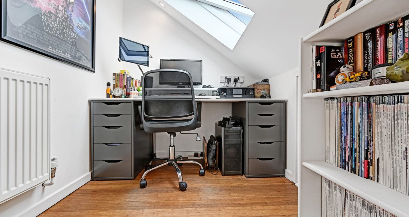 home office loft conversion with wood floor and large skylight