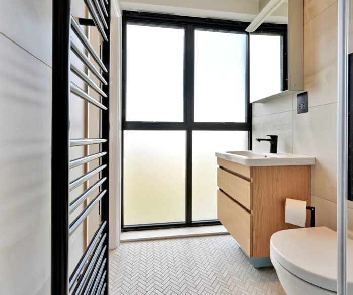beautiful dormer shower room with a glass wall in a loft conversion in Willesden Green