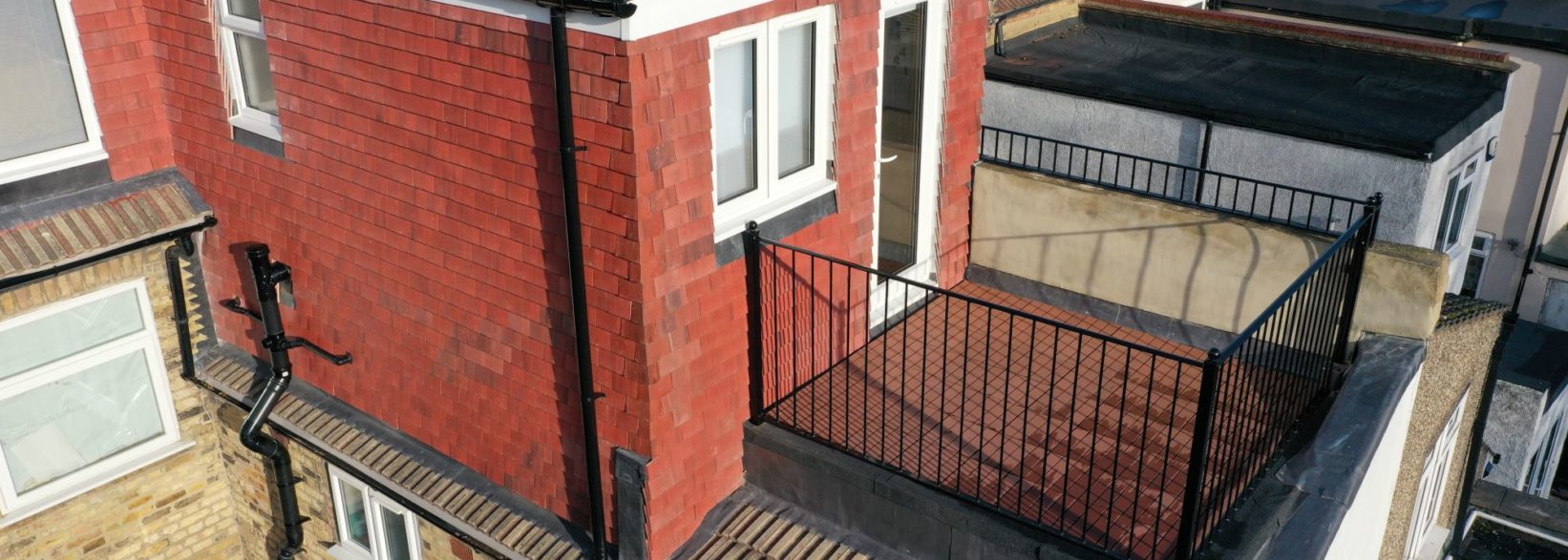 Exterior of a home office in L shaped dormer loft conversion with large roof terrace in Hornchurch RM14