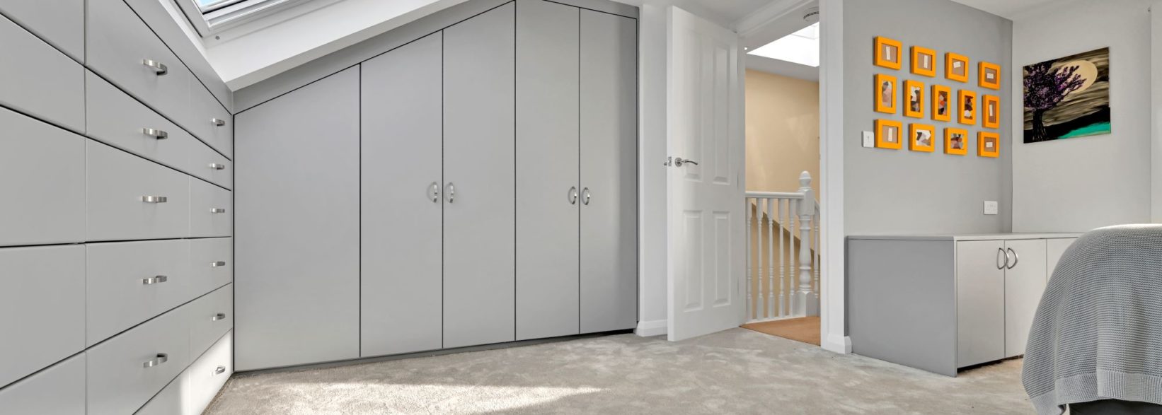 Bright and airy loft conversion master bedroom with large built in wardrobes and clothing storage at a home in Hornchurch RM14 Essex
