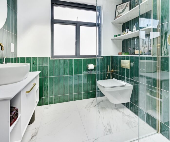Spacious bathroom with green tiling in Hackney E9 loft conversion