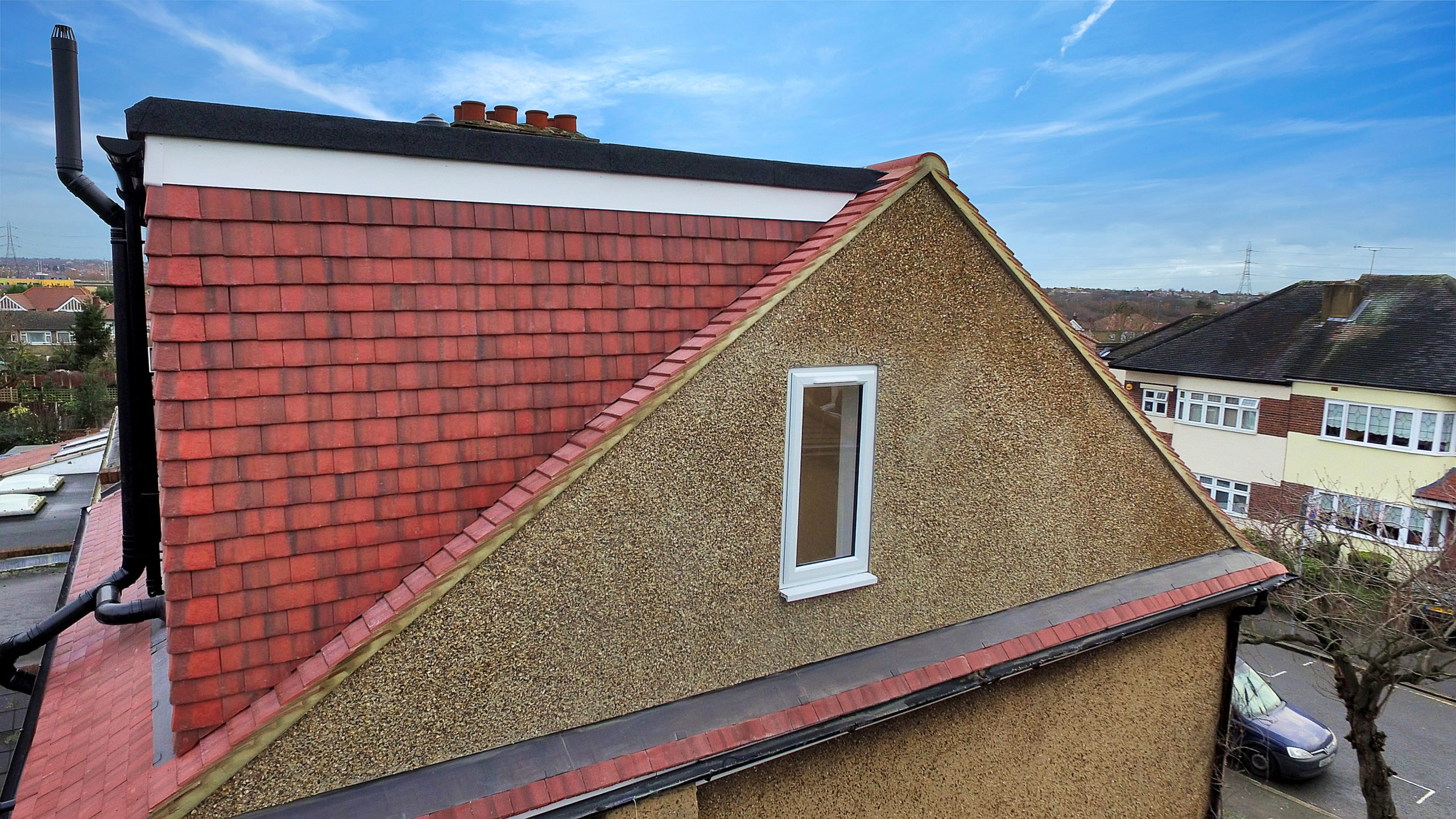 Barnet loft conversion hip to gable construction with a pebbledashed gable and red clay tiles.
