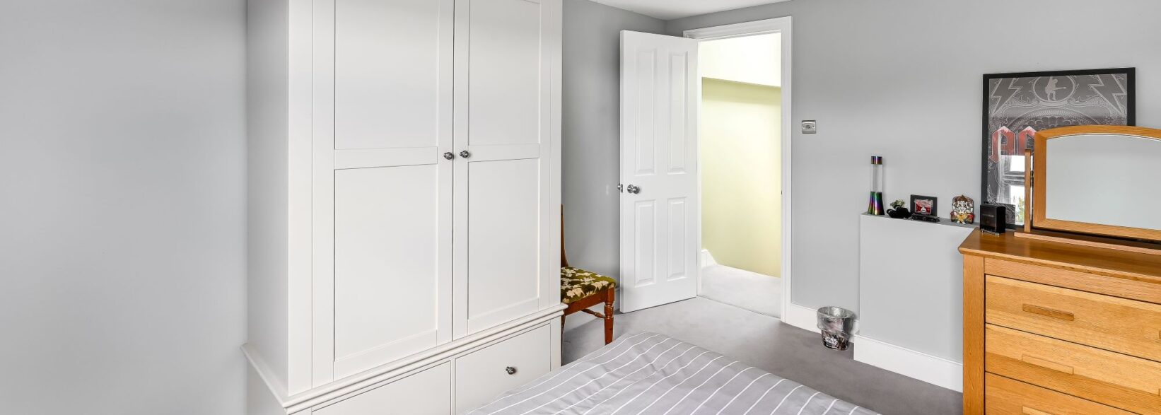 Bedroom in self-contained loft conversion Barnet North London with built-in wardrobes, storage drawers and independent living space