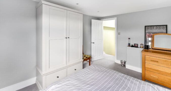 Bedroom in self-contained loft conversion Barnet North London with built-in wardrobes, storage drawers and independent living space