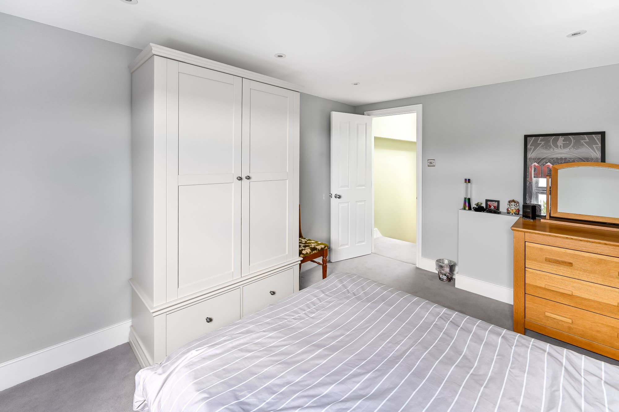 Bedroom in self-contained loft conversion Barnet North London with built-in wardrobes, storage drawers and independent living space