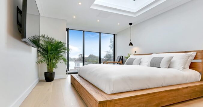 Bright loft conversion bedroom with roof lantern and large glazing for Archway loft design inspiration