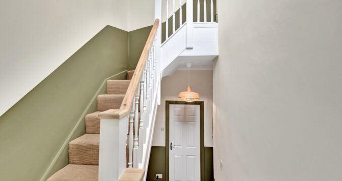 Loft conversion staircase with timber handrail, painted spindles and finished hallway for Archway page