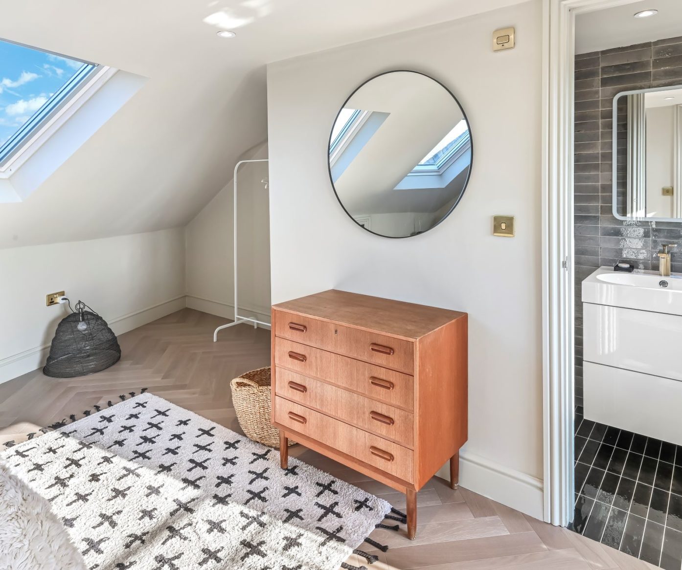 Master bedroom loft conversion in Balham with rooflight window and bright neutral bedroom design