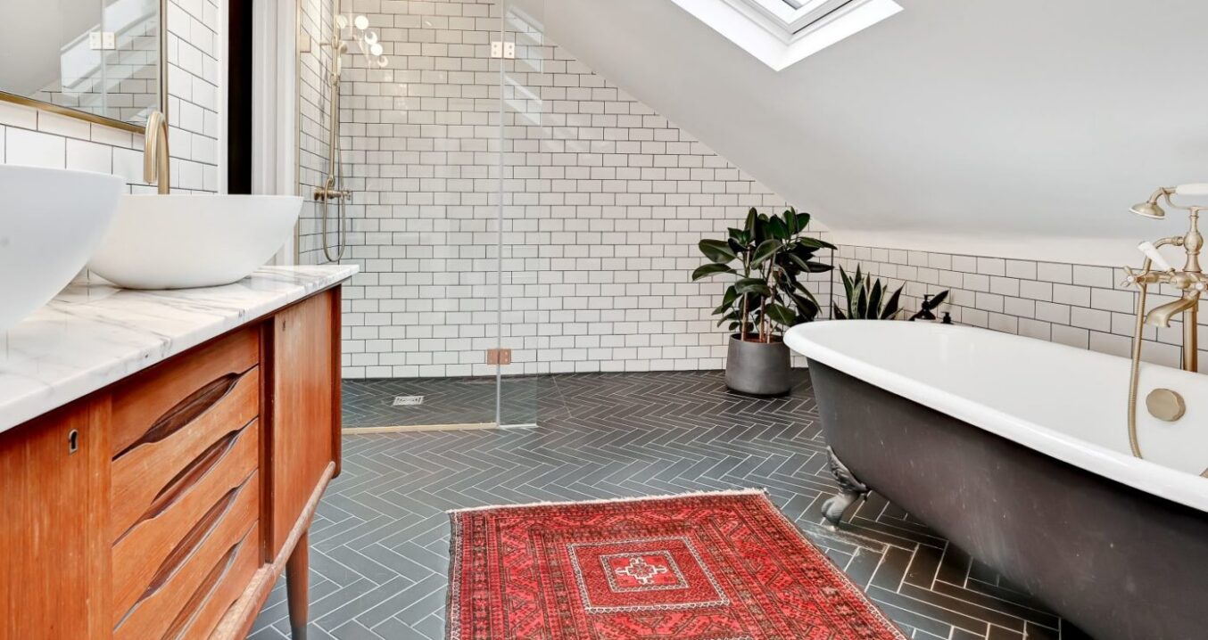 Loft bathroom in Beckenham BR3 with freestanding bath, walk in shower, vanity unit and roof window