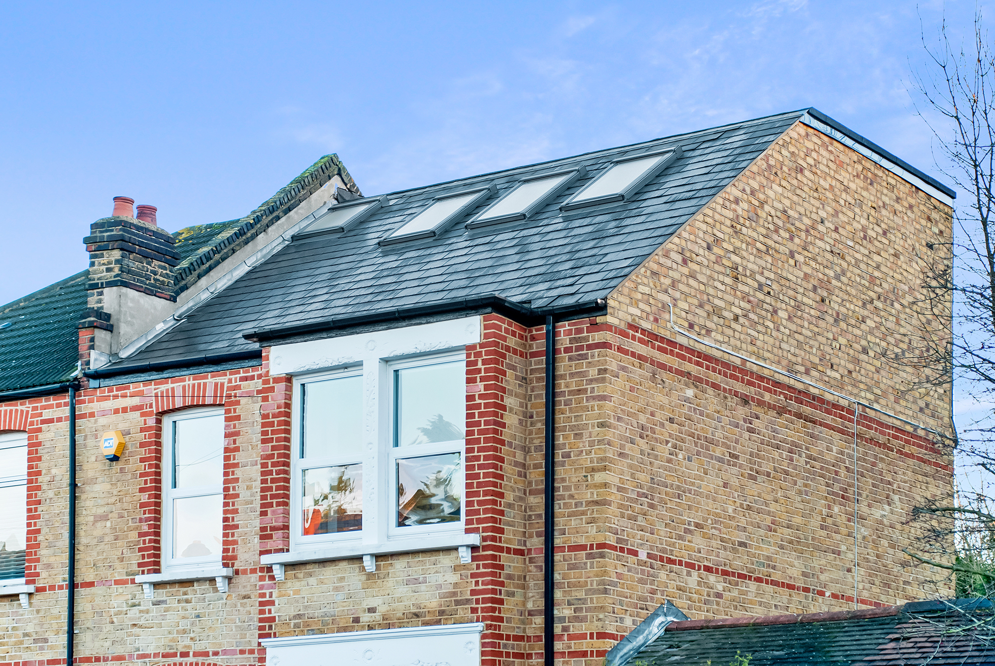 Exterior of a Borehamwood hip to gable loft conversion with extended roof structure and matching brickwork