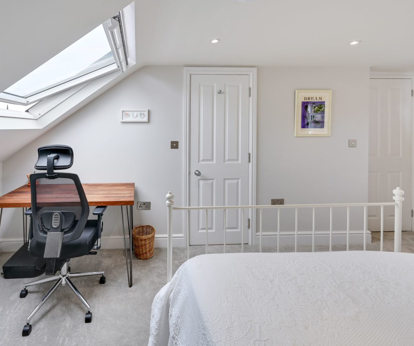 Loft conversion bedroom in Bromley with rooflight window, fitted desk and home office space