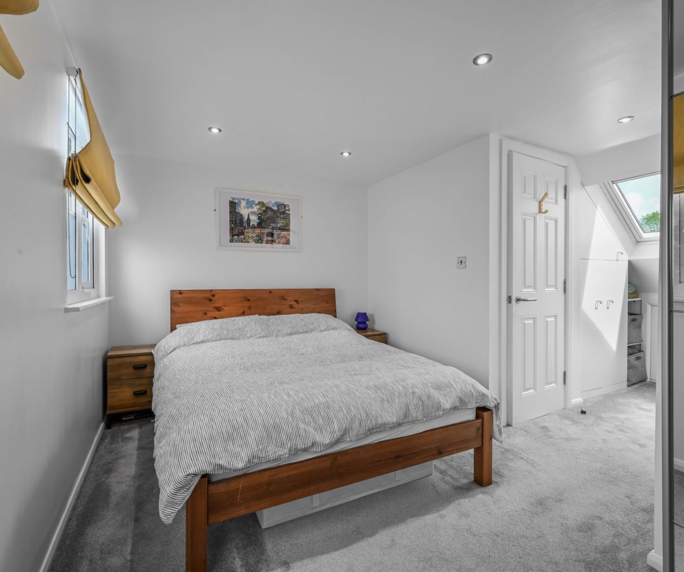 Double bedroom loft conversion in Bromley with grey carpet, white walls and modern fitted layout