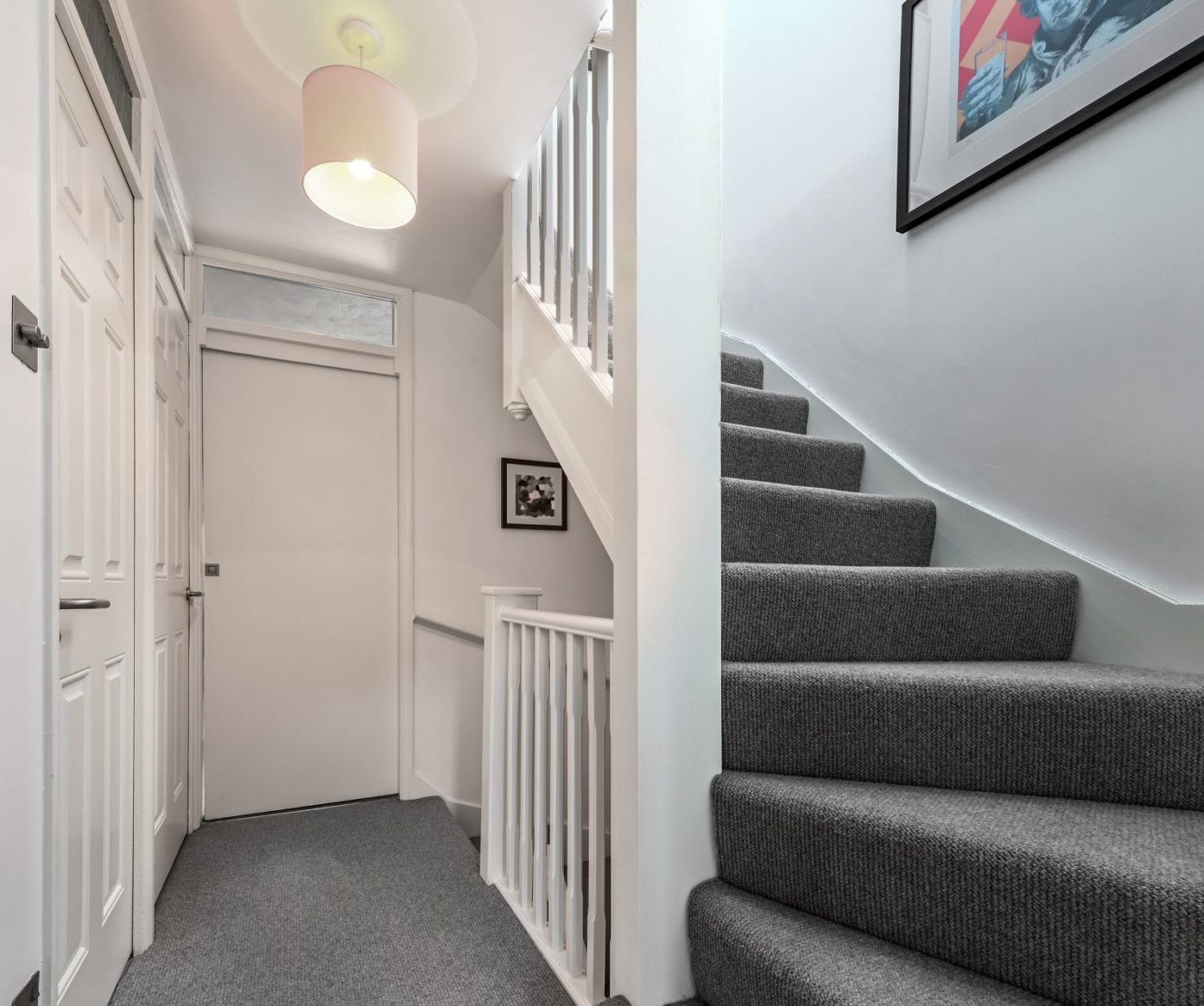 Loft conversion staircase in Bromley with grey carpet, white balustrade and modern landing area