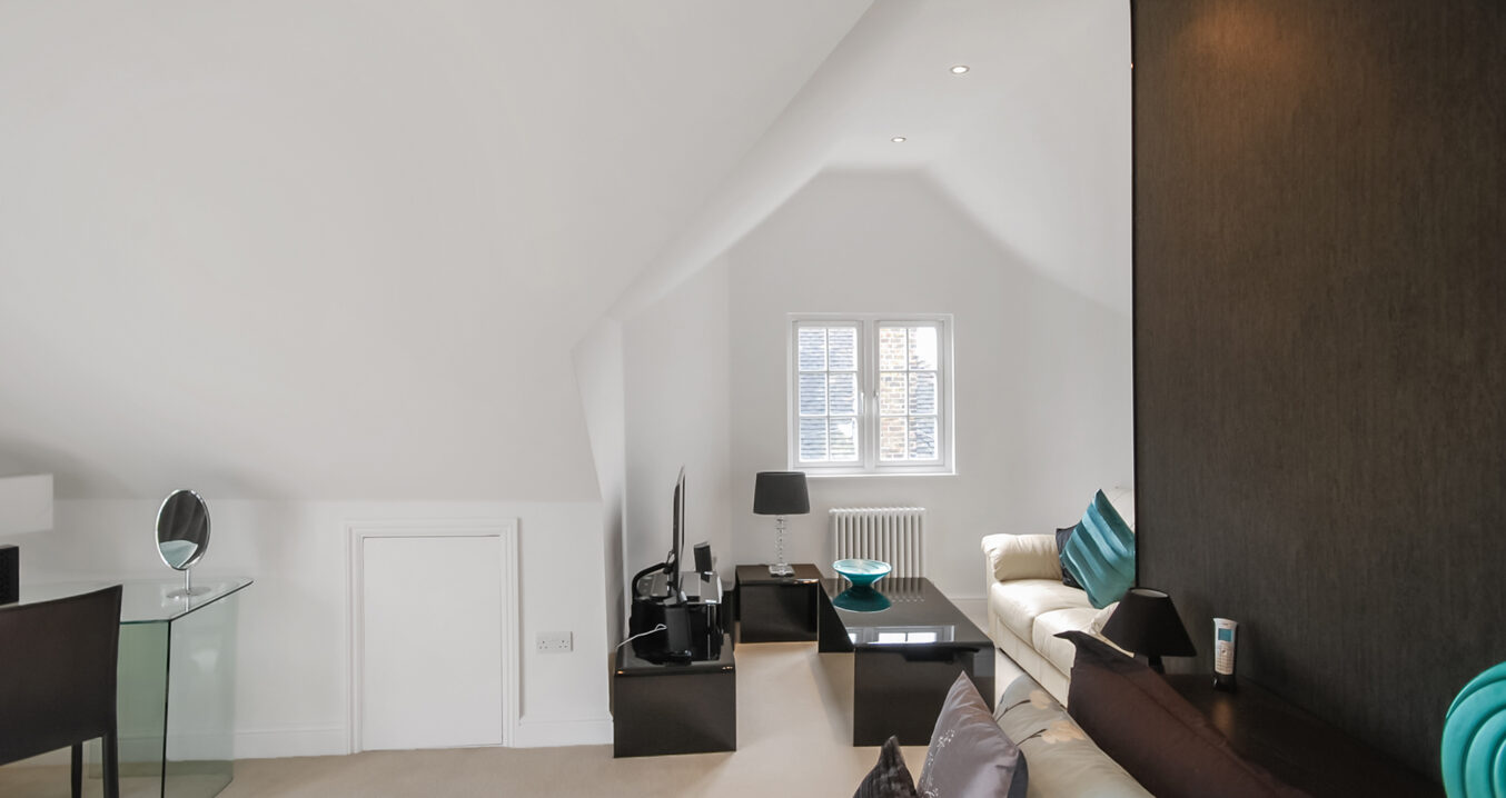 Side dormer loft conversion bedroom in Golders Green with vaulted ceiling and modern bright bedroom layout