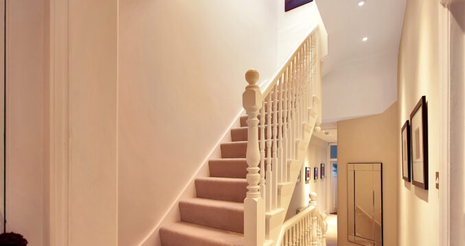 Loft conversion staircase in Golders Green leading to new loft bedroom with modern white staircase design