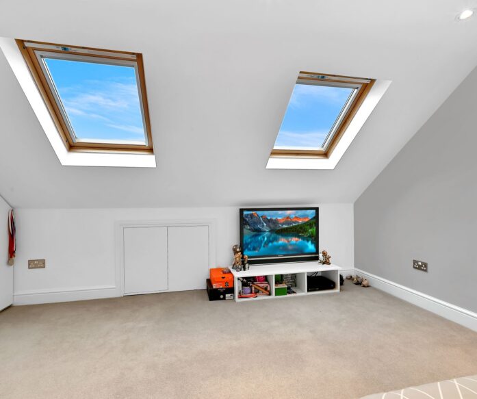 Velux loft conversion bedroom in Mill Hill with twin rooflights, fitted storage and bright open room layout