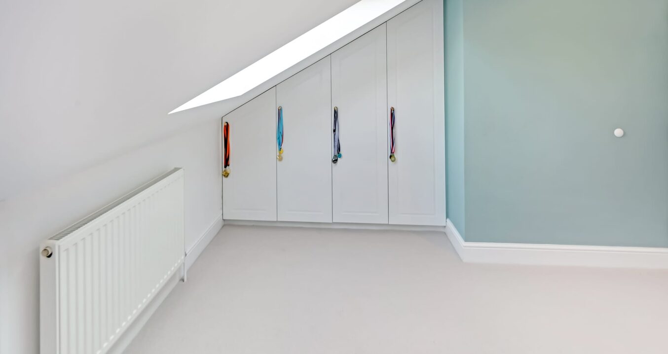 Loft conversion storage wardrobes in Sidcup fitted under eaves with clean modern finish