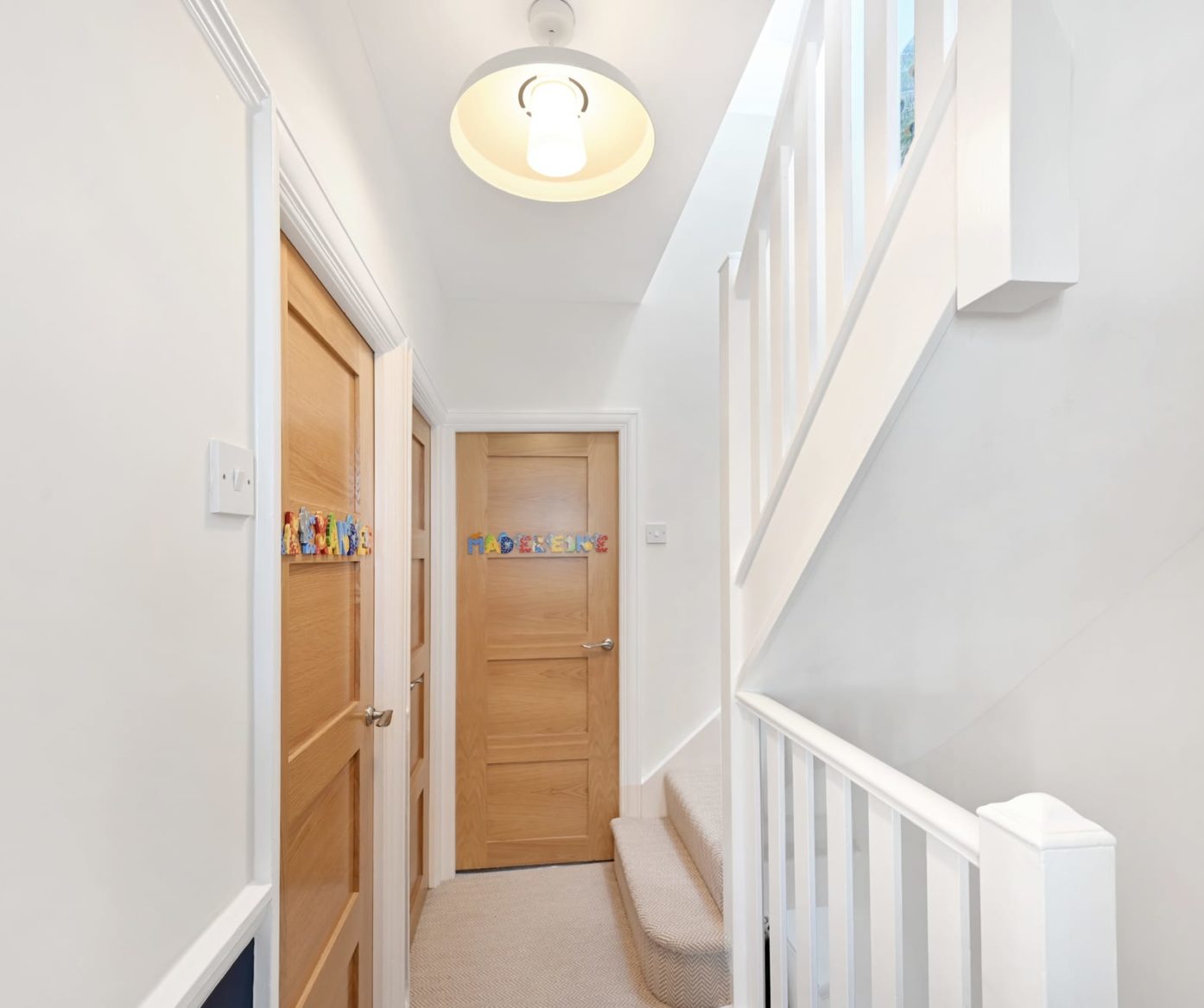 Newly built staircase and landing with natural wood doors in a dormer loft conversion Walthamstow E17