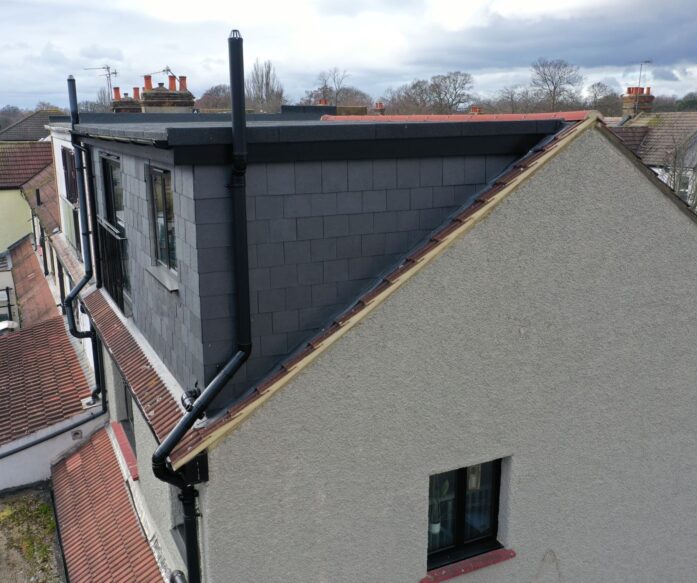 Rear dormer loft conversion in Stoke Newington with slate cladding, black guttering and modern external finish
