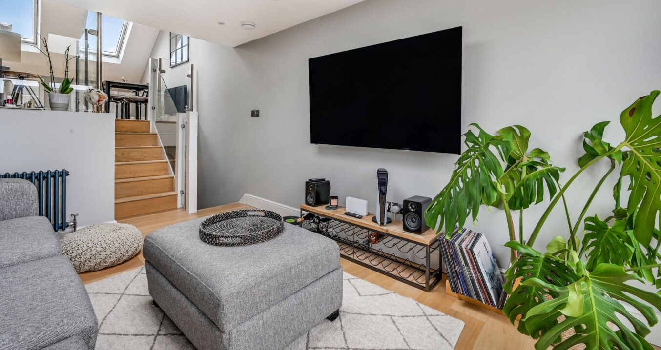 Modern loft lounge in Woolwich with media wall, rooflight window and open-plan living area