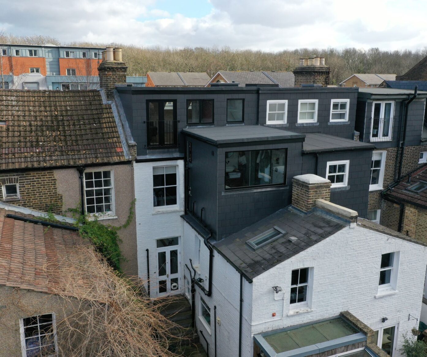 Rear dormer loft conversion in Woolwich with dark slate cladding, Juliet balcony and modern full width loft extension exterior