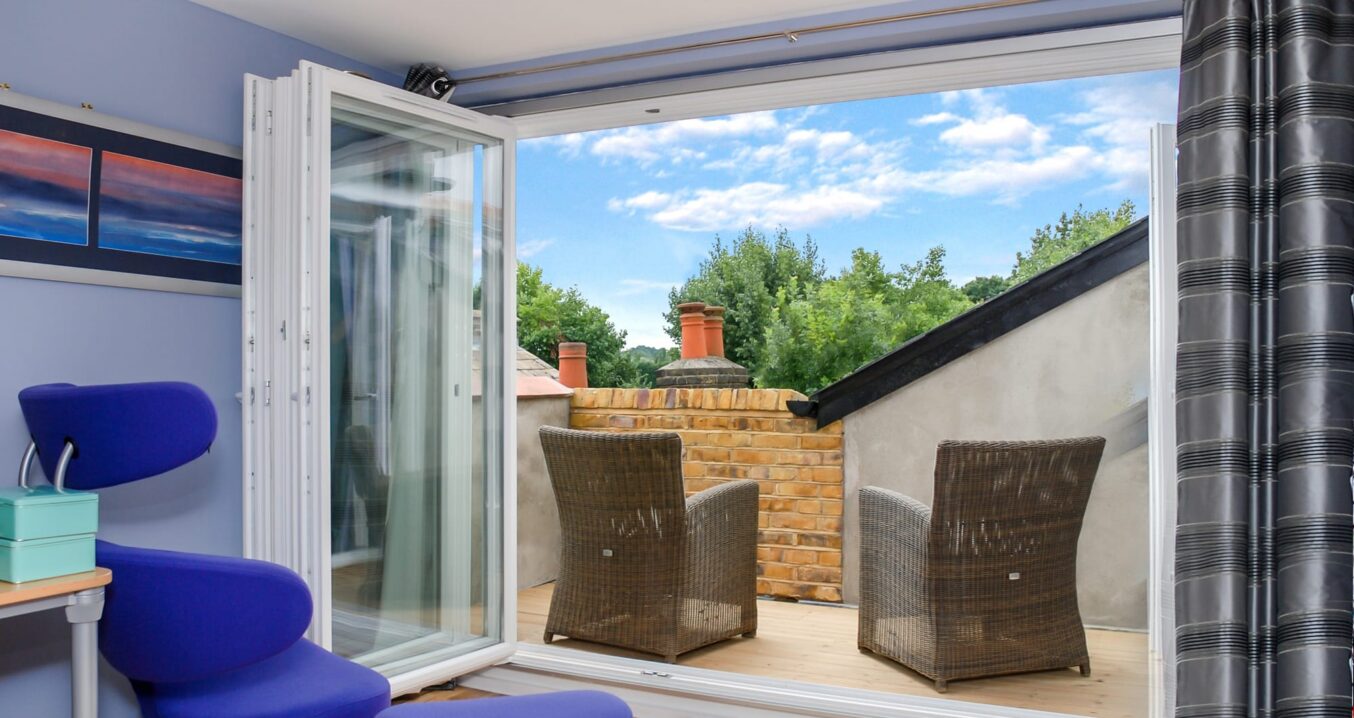 Loft conversion roof terrace in Woolwich with bi fold doors, seating area and private outdoor terrace