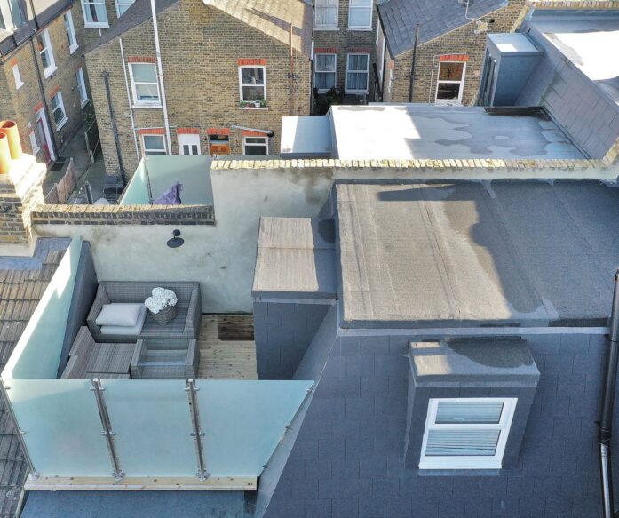 Mansard loft conversion featuring a private roof terrace with glass railings in Barnet area