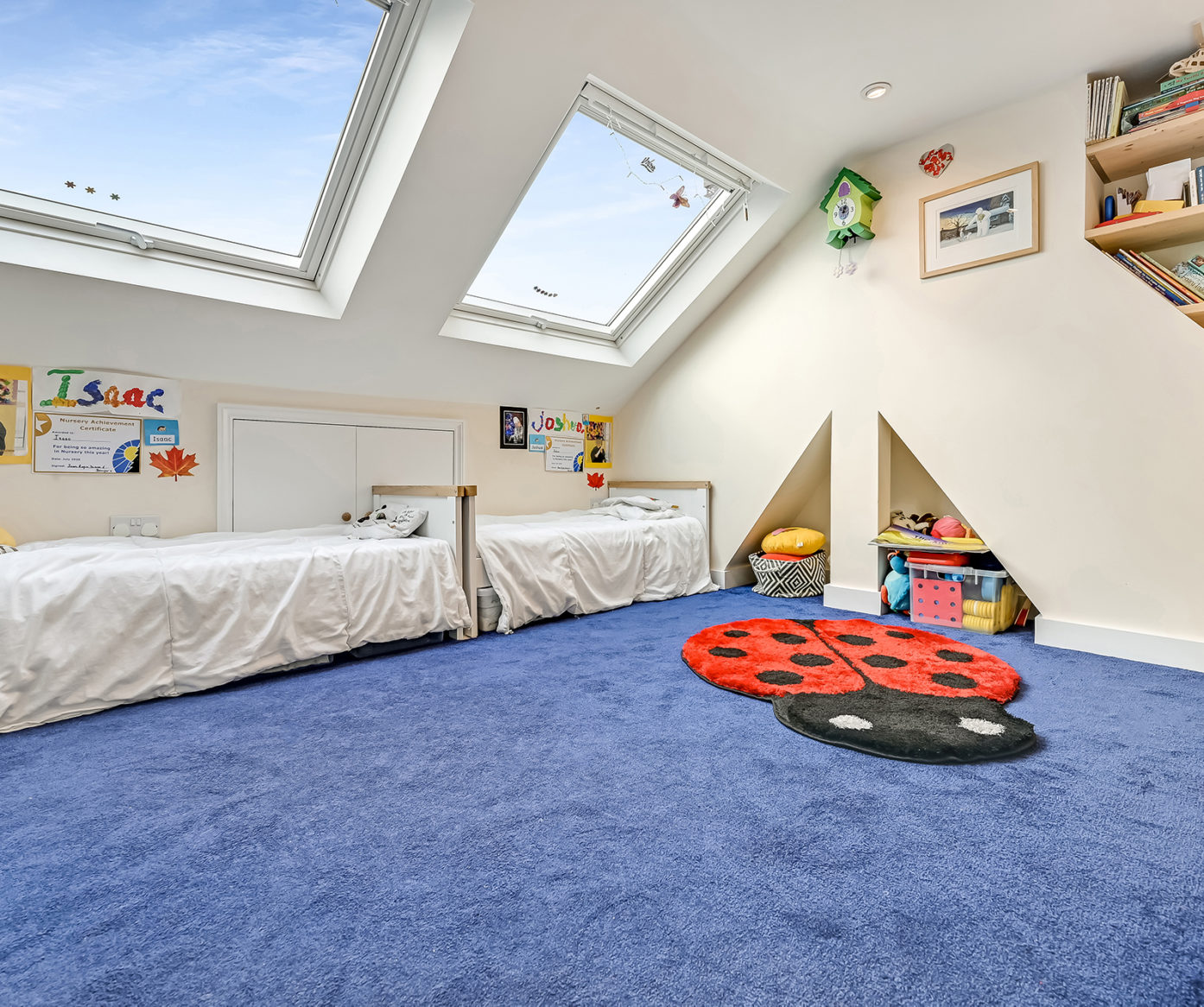 Loft bedroom with twin beds, roof lights and built in storage for a Plumstead SE18 family loft conversion