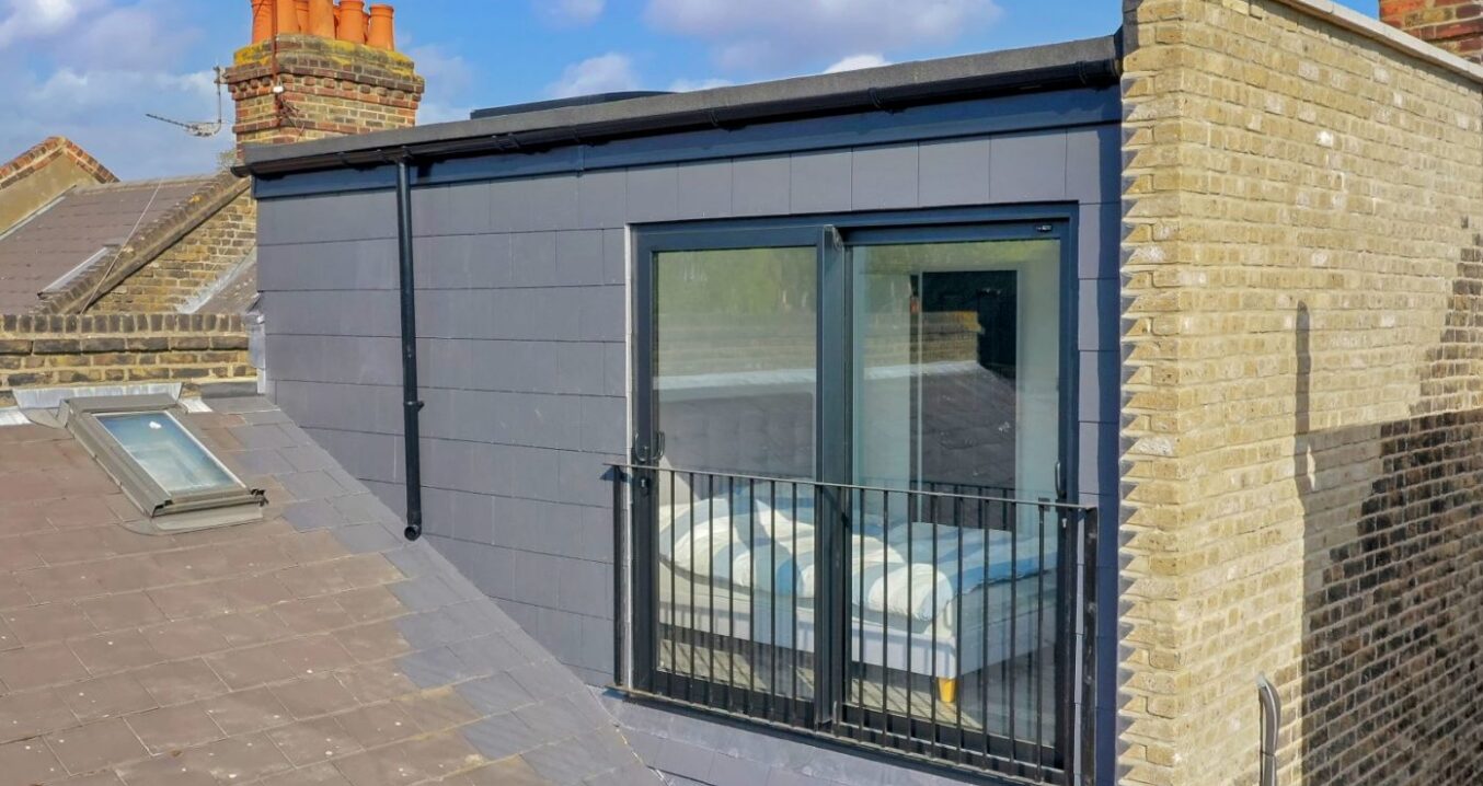 Loft conversion exterior with dark cladding, French doors and Juliet balcony for a Plumstead SE18 style property
