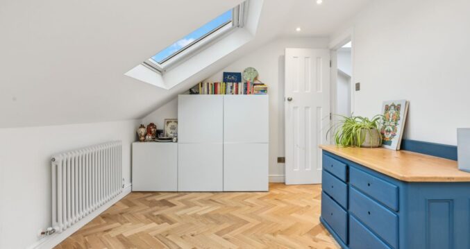 Bright Stanmore HA7 loft room with rooflight, herringbone floor and fitted storage