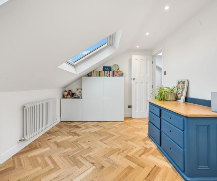 Bright Stanmore HA7 loft room with rooflight, herringbone floor and fitted storage