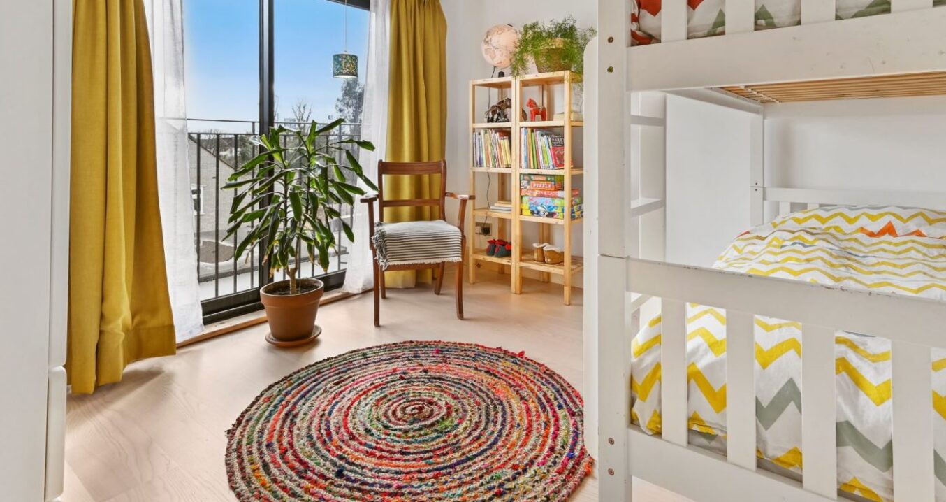 Children’s loft bedroom in Stanmore HA7 with bunk beds, circular rug and glazed doors