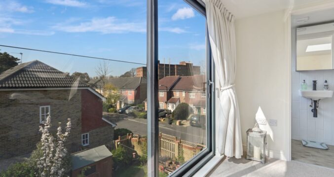 Loft conversion room with large French doors, Juliet balcony style glazing and open views for an Epping CM16 home.
