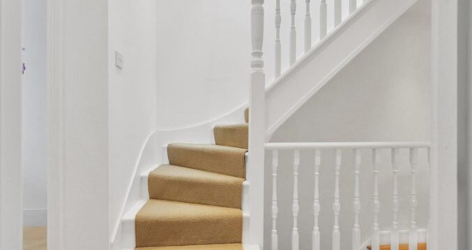 Loft conversion staircase with white painted balustrade and carpeted stairs for an Epping CM16 property.
