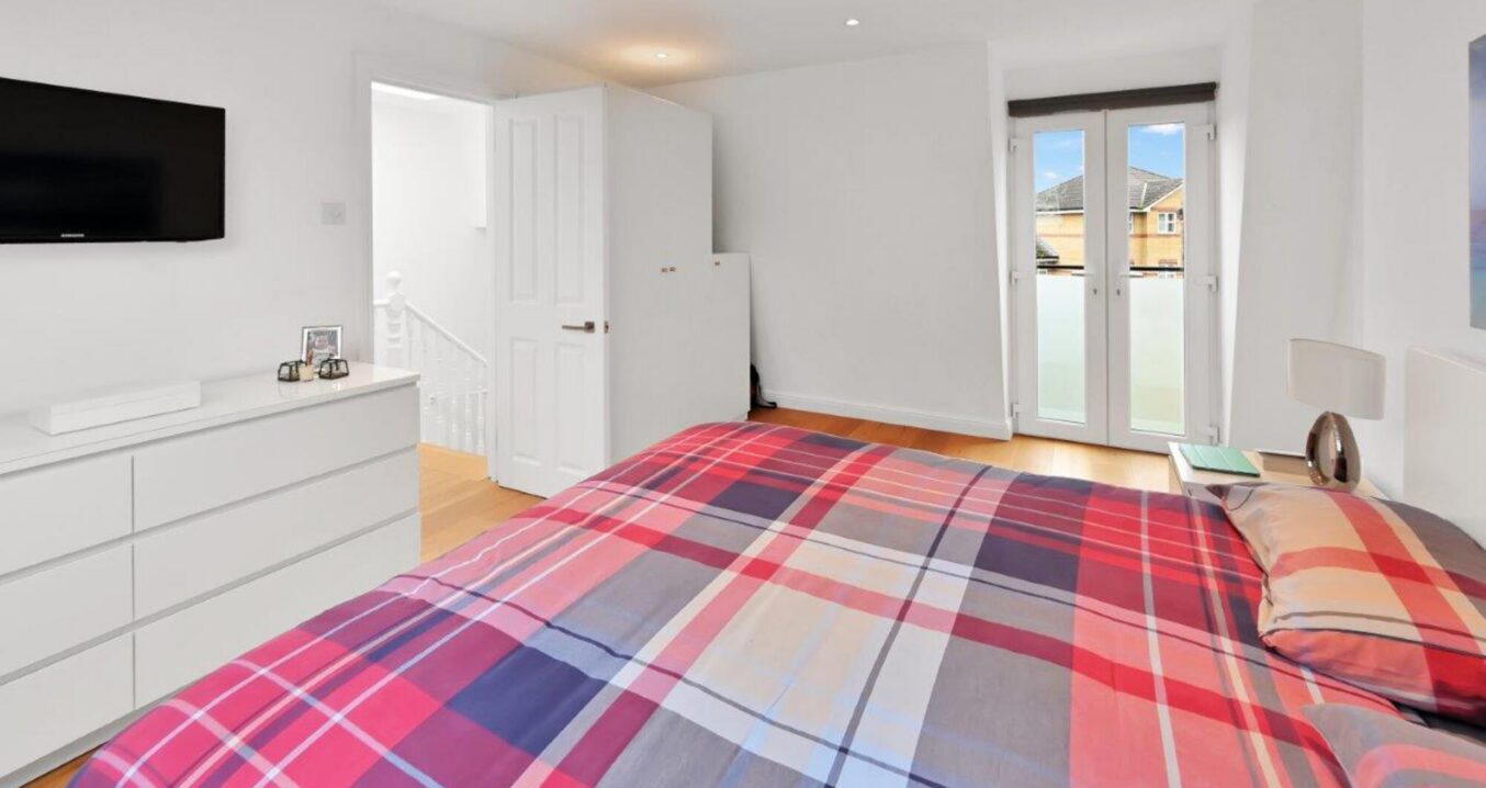 Loft conversion bedroom with French doors and Juliet style glazing, featured on the Loughton Our Work page.