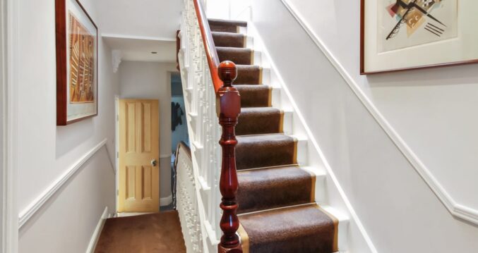 Traditional staircase leading up to the loft with period detailing and carpet runner in Palmers Green N13.