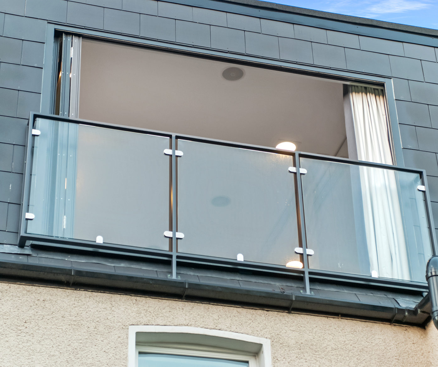 Dormer loft exterior with grey cladding, French doors and glass balcony, supporting Crystal Palace loft conversion exterior content.
