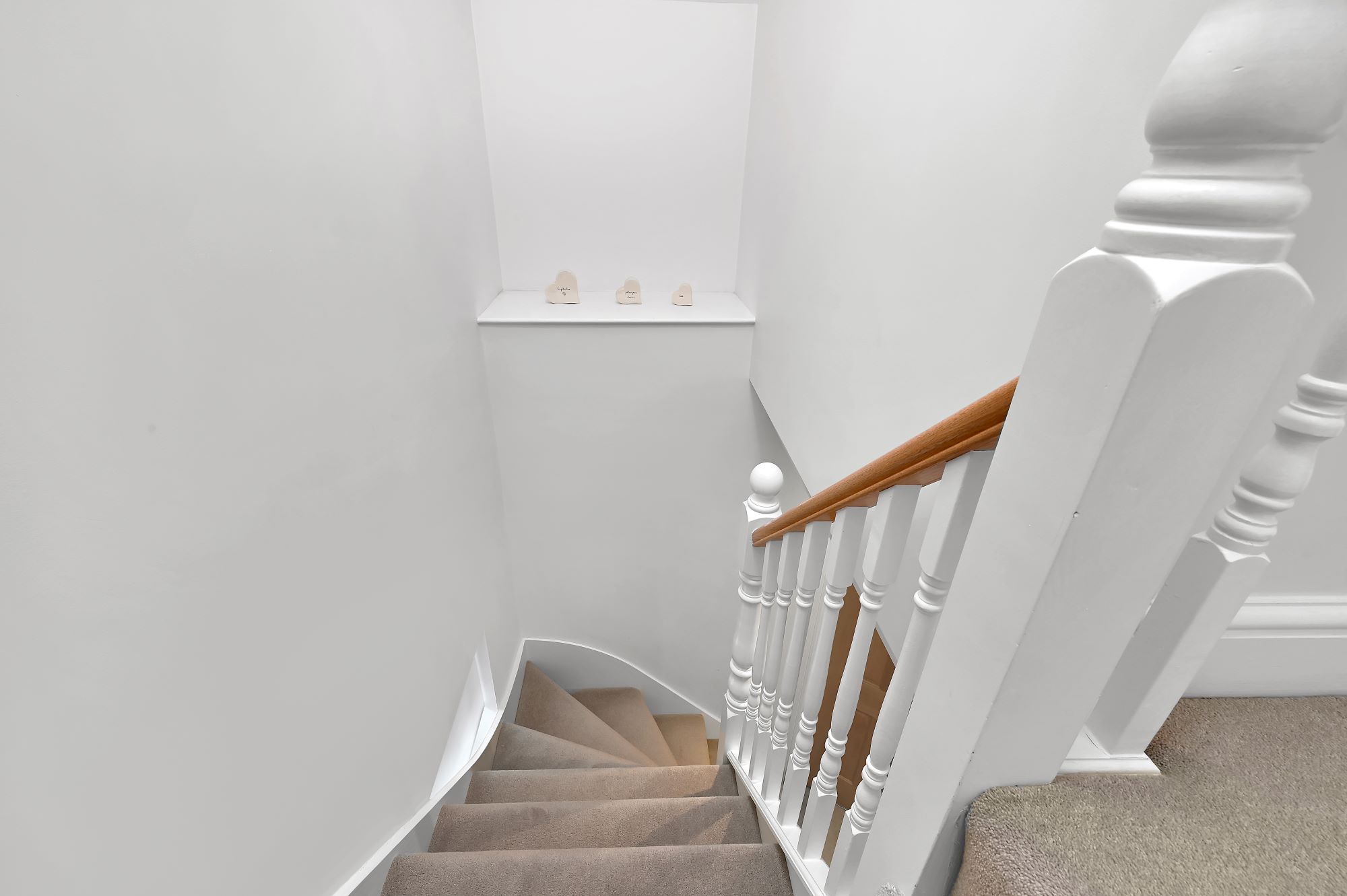 New loft staircase and landing with white balustrade and carpeted stairs in an Edgware HA8 loft conversion.