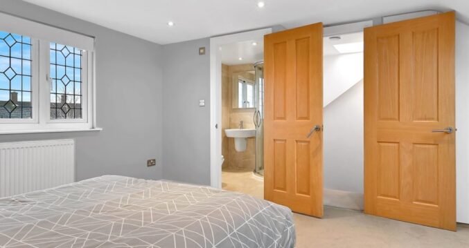 Dormer loft conversion bedroom with Velux roof windows, fitted wardrobes and eaves storage, featured on the Billericay CM12 page
