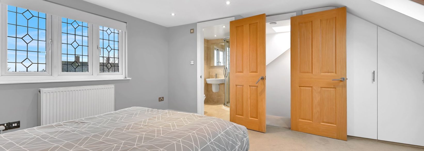 Dormer loft conversion bedroom with Velux roof windows, fitted wardrobes and eaves storage, featured on the Billericay CM12 page