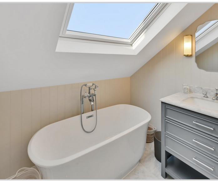 Loft home office with fitted desks, storage and a glazed door leading to a balcony in Winchmore Hill N21